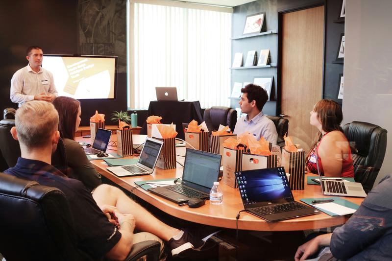 Team meeting around a conference table during a search briefing